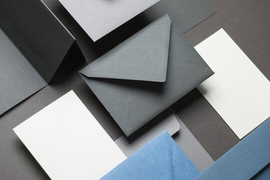 Floating envelopes and cards on dark gray background with shadow. Minimalism, modern business still life, creative layout