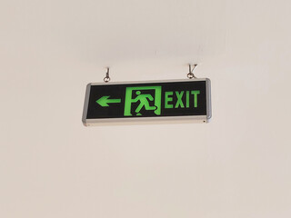 Illuminated Emergency Exit Sign with Running Man Symbol and Directional Left Arrow