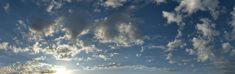 Russia, south of Western Siberia. Panoramic view of the evening sky with the setting sun and colorful clouds.
