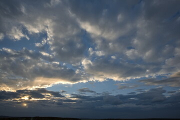 Russia, south of Western Siberia. Panoramic view of the evening sky with the setting sun and colorful clouds.