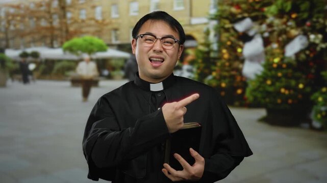 Priest outside city street holding bible near christmas tree vibrant background
