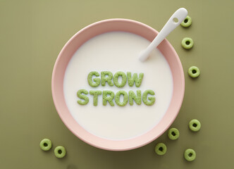 Naklejka premium “Grow Strong” Cereal Message in Milk Bowl on Green Background