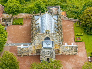 Aerial view of Rosslyn Chapel, it was founded in 1446 by Sir William St Clair. Rural Midlothian. Da Vinci Code movie. Ley lines and rose line. Edinburgh. Scotland. UK