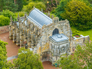Aerial view of Rosslyn Chapel, it was founded in 1446 by Sir William St Clair. Rural Midlothian. Da Vinci Code movie. Ley lines and rose line. Edinburgh. Scotland. UK