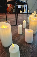 Burning candles on the stage where musical instruments are placed