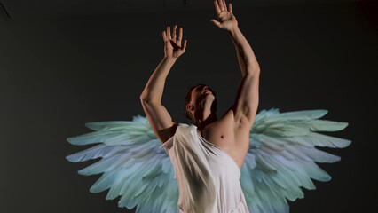 Fototapeta premium Renaissance-style warrior angel concept: powerful male figure in classical white robe. Muscular battle angel in white tunic, inspired by Renaissance art and classical sculpture style