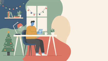Man working remotely on a tablet in a cozy Christmasdecorated home office Copy space