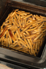 French fries cooking in the deep fryer.