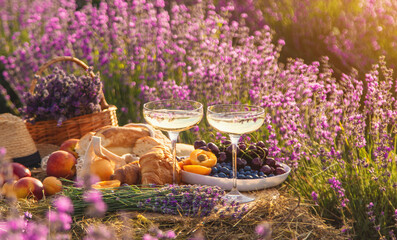 Picnic with wine in a lavender field. Selective focus.
