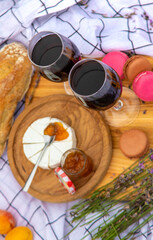 A woman drinks wine in a lavender field. Selective focus.