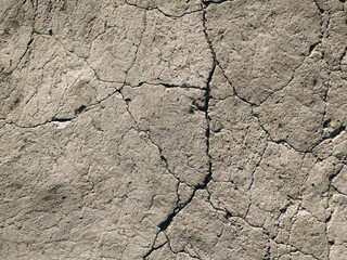 Top view of rocks and old, gray, cracked concrete. Grunge, artificial backdrop.