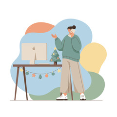 A woman talks on a phone at her festive WFH desk during the Christmas holiday season