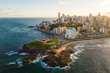 Aerial View of Barra Lighthouse on the Rock in the Ocean With Salvador Cityscape on Sunrise in Bahia State of Brazil