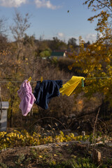 Clothes drying on a line outdoors with autumn landscape