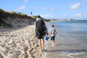 Rear view of a family walking on the beach in H&ouml;rnum on the island of Sylt