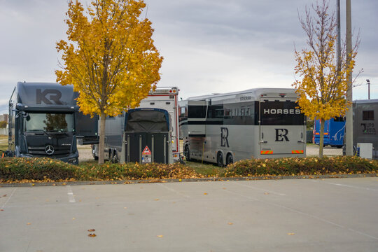 Bratislava, Slovakia, Europe - Oct 25, 2025: large horse transporter trucks and trailers parked in an autumn equestrian event lot concept of horse riding, logistics, animal transport
