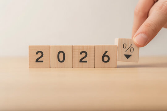 Wooden blocks showing the year 2026 with a percentage sign pointing down suggesting a decrease or reduction business forecast concept