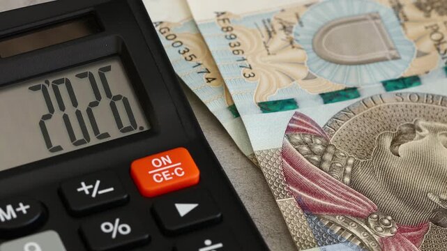 . Poland. Fiscal year 2026. Business and economic concept. Symbol of the Polish zloty. Counting money. 500 zloty banknotes. The year 2026 displayed on a calculator. Financial background