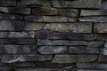 stacked stone wall texture background concept of building construction, architecture, landscaping