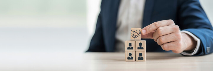 Building a successful team wooden blocks with people icons concept for human resources and teamwork