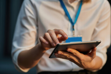Close up of data center engineering team using tablet to inspect gear, doing maintenance tasks. Server farm coworkers using device to conduct system checks on network rigs