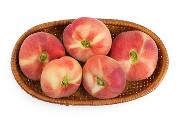 chinese flat donut peaches in a wicker basket isolated on white background. Top view. Flat lay