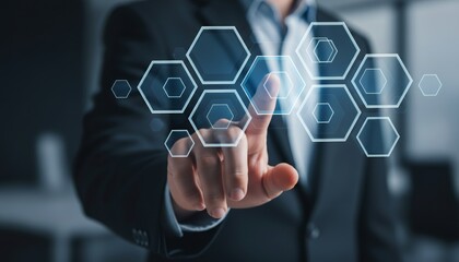 Businessman interacting with futuristic digital interface of interconnected hexagons.