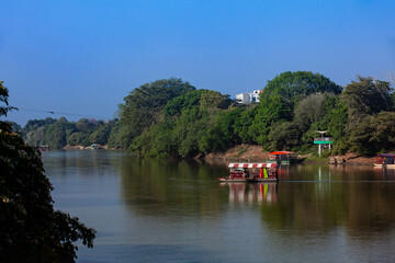 Fototapeta premium Non motorized ferry, called planchon, used by residents to cross the Sinú River from one bank to the other in the city of Montería, Colombia.