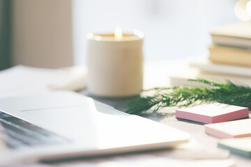 Desk scene with a laptop closed, blank sticky notes in soft colors, ceramic candle, evergreen clipping, morning light, organized New Year workspace, ample copy space