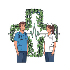 A doctor and nurse pair posing next to a large nature-inspired cross design with heartbeat symbols