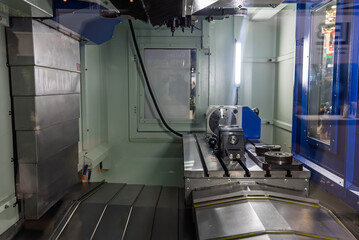 Milling machine with a rotary table. Multi axis CNC machine. Five-axis milling machining center. Interior of a CNC 5 axis milling machine