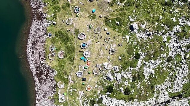 Bucura Lake camping and Retezat Mountains aerial view in Romania