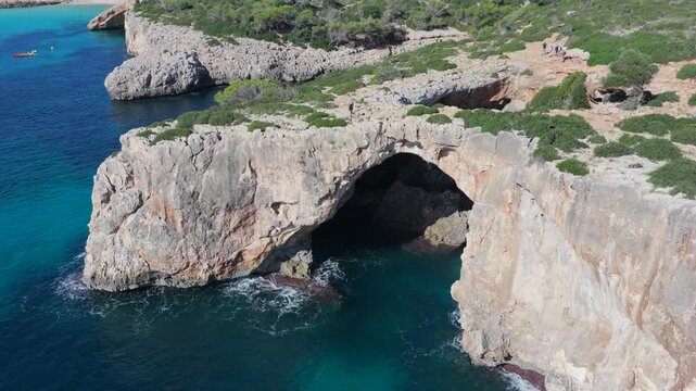 Aerial view of Cala Varques suspended rock arch above the mediterranean sea in mallorca