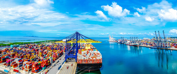 Aerial top view over international cargo ship at industrial import-export port prepare to load...