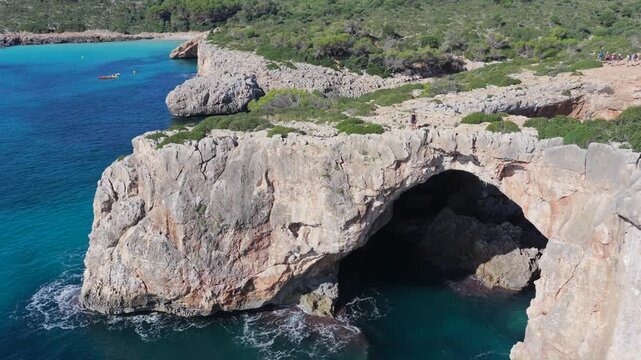 Aerial view of Cala Varques suspended rock arch above the mediterranean sea in mallorca