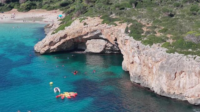 Aerial View Crystal Clear Turquoise Waters, Sea Caves, and Natural Arch of Cala Varques, Mallorca