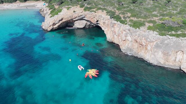 Aerial View Crystal Clear Turquoise Waters, Sea Caves, and Natural Arch of Cala Varques, Mallorca