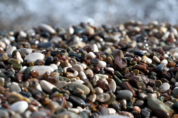 Colorful pebble stones on the beach, pebbles on the beach of Antalya, close-up, background