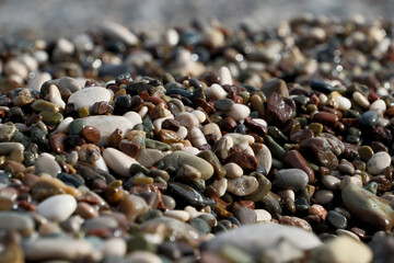 Colorful pebble stones on the beach, pebbles on the beach of Antalya, close-up, background