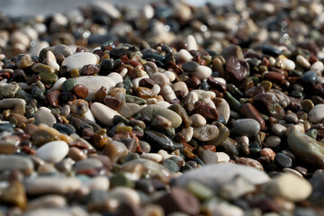 Colorful pebble stones on the beach, pebbles on the beach of Antalya, close-up, background