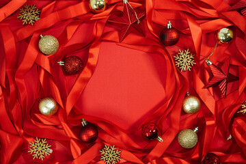 Christmas background of red satin ribbons and Christmas decorations with copy space