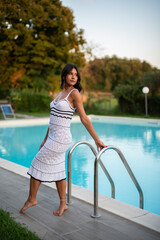 woman in white dress at pool