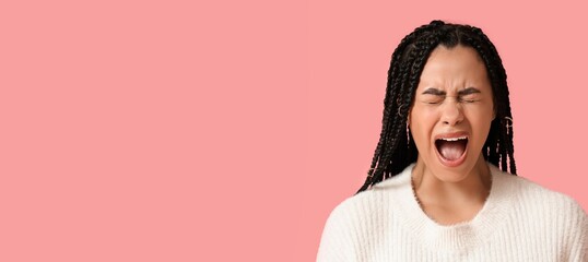 African-American woman screaming on pink background with space for text
