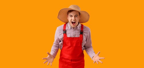 Angry young farmer on yellow background