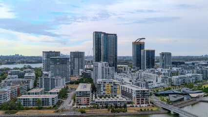 Fototapeta premium Aerial Drone View of Wentworth Point and Rhodes a suburb in western Sydney newly built residential high rise apartments area on Parramatta River Sydney NSW Australia