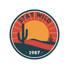 Embrace adventure with this retro desert sunset badge featuring cacti and "Stay Wild"