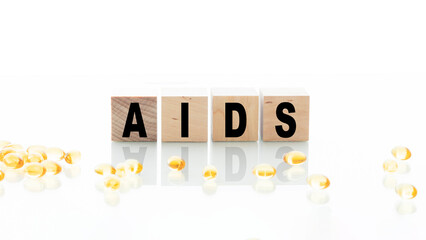 Wood blocks spelling AIDS HIV on the table. Medicine concept.