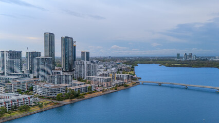 Obraz premium Aerial Drone View of Wentworth Point and Rhodes a suburb in western Sydney newly built residential high rise apartments area on Parramatta River Sydney NSW Australia