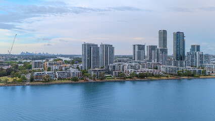 Naklejka premium Aerial Drone View of Wentworth Point and Rhodes a suburb in western Sydney newly built residential high rise apartments area on Parramatta River Sydney NSW Australia
