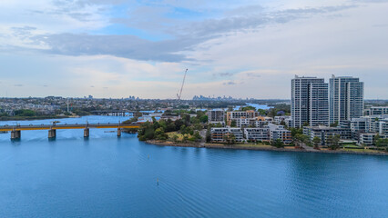 Obraz premium Aerial Drone View of Wentworth Point and Rhodes a suburb in western Sydney newly built residential high rise apartments area on Parramatta River Sydney NSW Australia